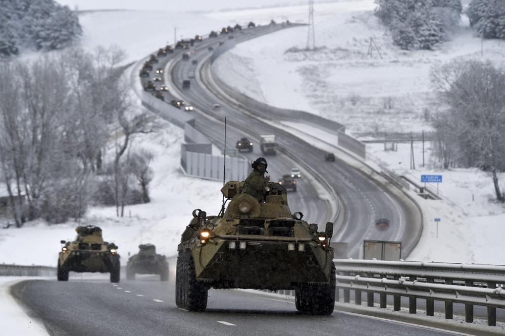 A convoy of Russian armored vehicles moves along a highway in Crimea, Tuesday, Jan. 18, 2022. Russia has concentrated an estimated 100,000 troops with tanks and other heavy weapons near Ukraine in what the West fears could be a prelude to an invasion. (AP Photo)