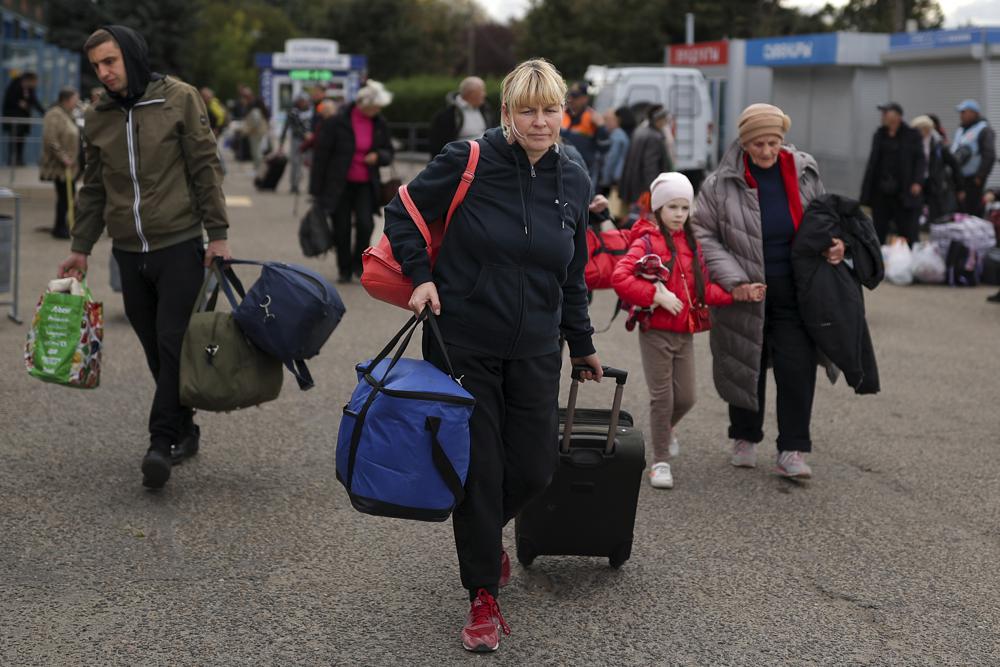 FILE - Evacuees from Kherson arrive at the railway station in Anapa, southern Russia, Oct. 25, 2022. Russia relinquished its final foothold in a major city in southern Ukraine on Friday Nov. 11, 2022, clearing the way for victorious Ukrainian forces to reclaim the country’s only Russian-held provincial capital that could act as a springboard for further advances into occupied territory. (AP Photo, File)