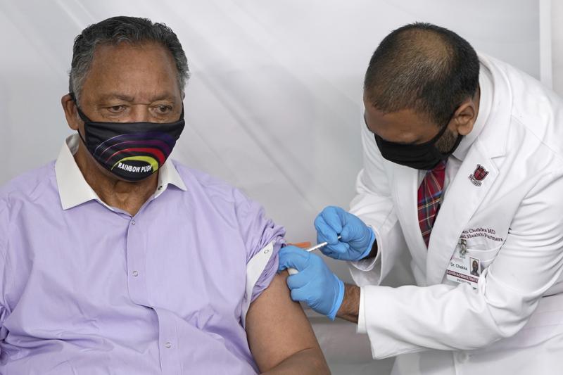 FILE - In this Friday, Jan. 8, 2021 file photo, Rev. Jesse Jackson receives the Pfizer's BioNTech COVID-19 vaccine from Dr. Kiran Chekka, Covid Administration Physician at the Roseland Community Hospital in Chicago. The Rev. Jesse Jackson and his wife, Jacqueline, have been hospitalized after testing positive for COVID-19 according to a statement Saturday, Aug. 21, 2021. He is vaccinated against the virus and publicly received his first dose in January. According to a statement released Saturday evening, the Jacksons are being treated at Northwestern Memorial Hospital in Chicago. He is 79 years old. Jacqueline Jackson is 77.  (AP Photo/Charles Rex Arbogast, File)