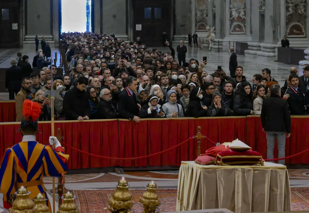 In this image released on Monday, Jan. 2, 2023, by the Vatican Media news service, the body of late Pope Emeritus Benedict XVI is lied out in state inside St. Peter's Basilica at The Vatican where thousands went to pay their homage. Pope Benedict, the German theologian who will be remembered as the first pope in 600 years to resign, has died, the Vatican announced Saturday, Dec. 31, 2022. He was 95. (Vatican Media via AP)