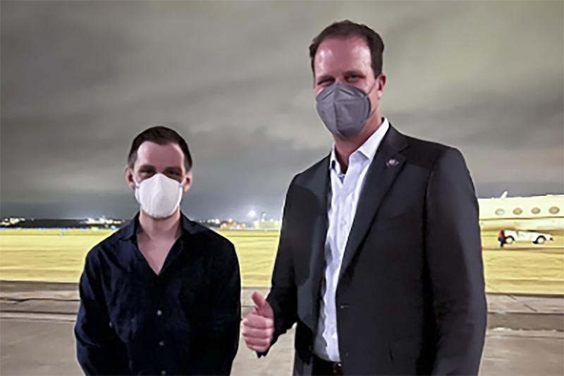 Trevor Reed, left, a Texas resident arrested in Russia in 2019, is greeted by Rep. August Pfluger, R-Texas, at a military airfield in Texas, Thursday, April 28, 2022. (Jonathan Franks via AP)