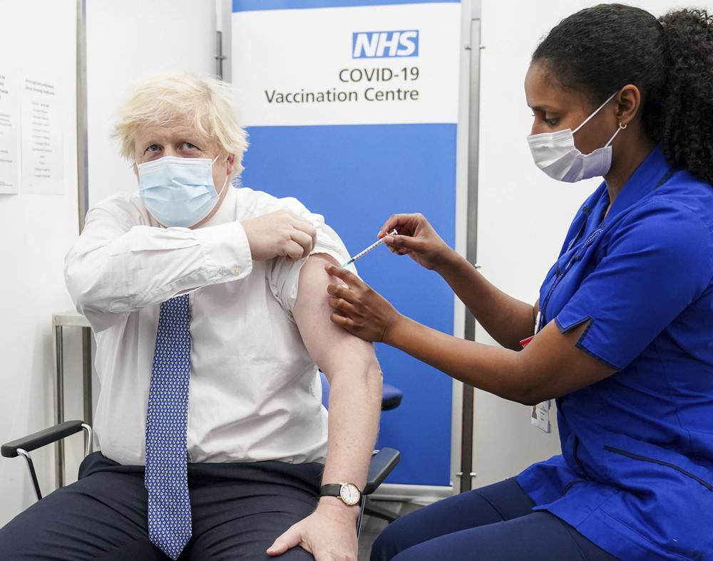 Britain's Prime Minister Boris Johnson receives his booster jab of the coronavirus vaccine at St Thomas Hospital in London, Thursday, Dec. 2, 2021 as the Government accelerates the Covid booster programme to help slow down the spread of the new Omicron variant. (Paul Edwards/Pool Photo via AP)