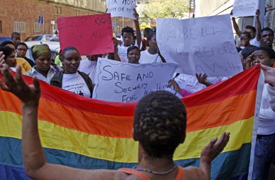 FILE - Women in Cape Town, South Africa, protest a sentence given to two men under Malawi's anti-gay legislation on May 20, 2010. Desmond Tutu is being remembered for his passionate advocacy on behalf of LGBTQ people as well as his fight for racial justice. But the South African archbishop's campaign against homophobia had limited impact in the rest of Africa. (AP Photo/Schalk van Zuydam, File)