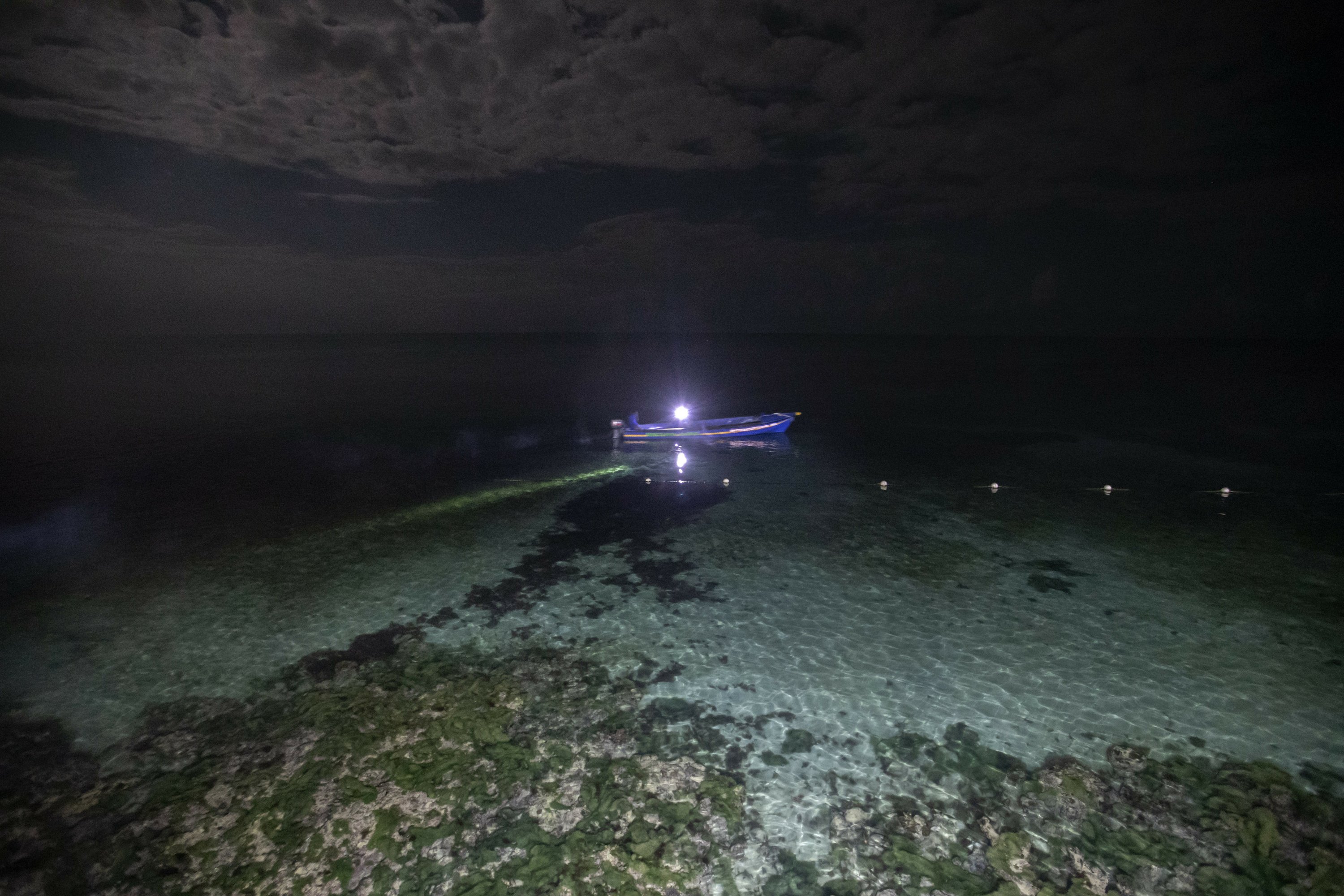 AP Photos: Night fishing in moonlit sea in eerie silence