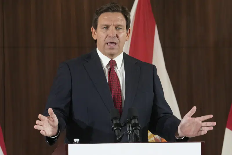 FILE - Florida Gov. Ron DeSantis listens to others during a news conference where he spoke of new law enforcement legislation that will be introduced during the upcoming session, Jan. 26, 2023, in Miami. David McIntosh, the president ofthe influential Club For Growth group, said Tuesday, Feb. 7, that the group has invited a half dozen potential Republican candidates for the White House to its donor summit in Florida next month including DeSantis. (AP Photo/Marta Lavandier, File)