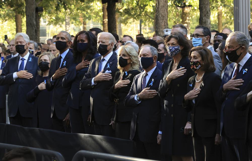 From left, former President Bill Clinton, former First Lady Hillary Clinton, former President Barack Obama, Michelle Obama, President Joe Biden, first lady Jill Biden, former New York City Mayor Michael Bloomberg, Bloomberg's partner Diana Taylor, Speaker of the House Nancy Pelosi, D-Calif., and Senate Minority Leader Charles Schumer, D-N.Y., stand for the national anthem during the annual 9/11 Commemoration Ceremony at the National 9/11 Memorial and Museum on Saturday, Sept. 11, 2021 in New York. (Chip Somodevilla/Pool Photo via AP)