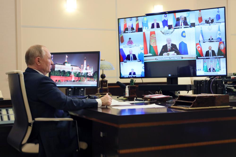 Russian President Vladimir Putin takes part in a virtual Summit of leaders from the Commonwealth of Independent States (CIS) at the Novo-Ogaryovo residence outside Moscow, Russia, Friday, Oct. 15, 2021. (Evgeniy Paulin, Sputnik, Kremlin Pool Photo via AP)