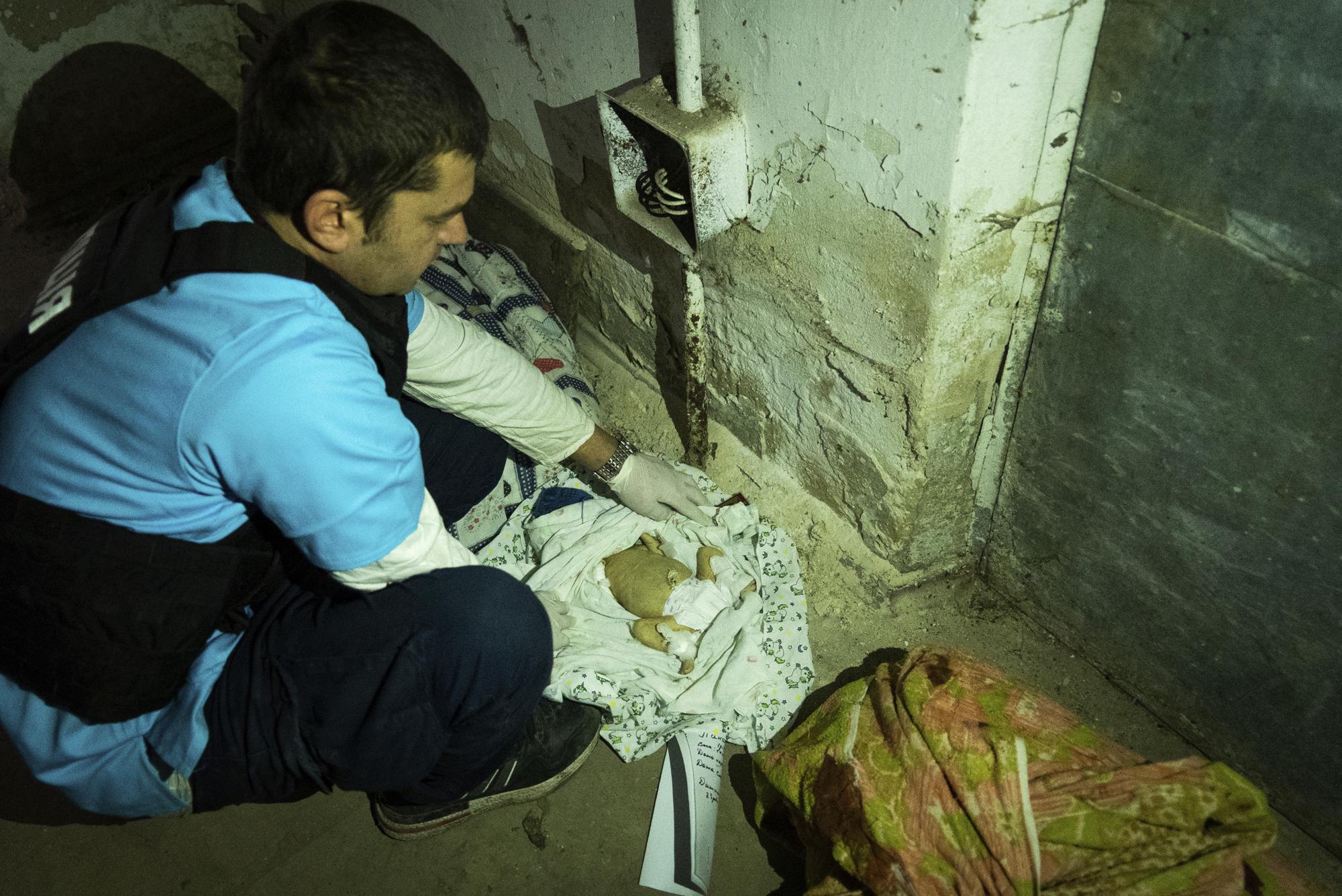 A doctor shows bodies of children killed by shelling at No. 3 hospital in Mariupol, Ukraine, Tuesday, March 15, 2022. (AP Photo/Mstyslav Chernov)