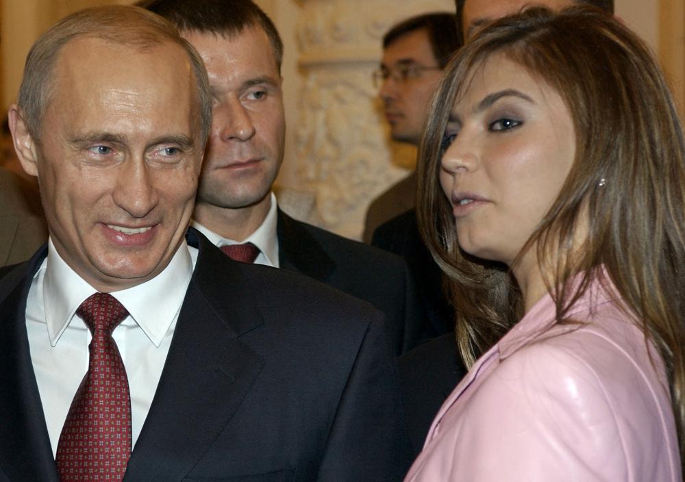 FILE - In this Thursday, Nov. 4, 2004 file photo President Vladimir Putin, left, speaks with gymnast Alina Kabaeva at a Kremlin banquet in Moscow, Russia. AP/RSS Photo