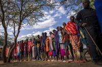 Maasai wait in line to cast their votes in the general election at a polling station in Esonorua Primary School, in Kajiado County, Kenya Tuesday, Aug. 9, 2022. Polls opened Tuesday in Kenya's unusual presidential election, where a longtime opposition leader who is backed by the outgoing president faces the deputy president who styles himself as the outsider. (AP Photo/Ben Curtis)