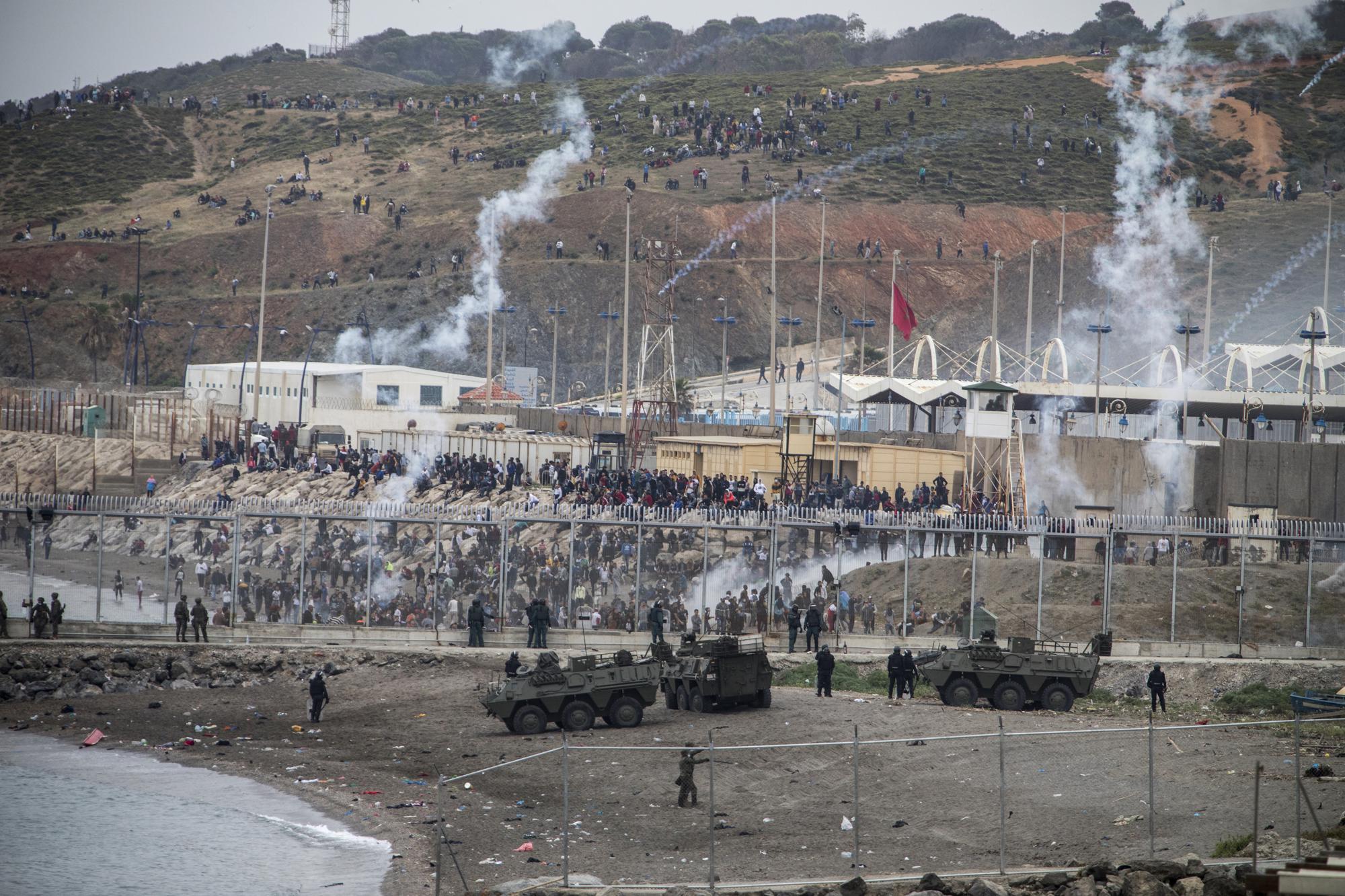 Spanish Army and Guardia Civil officers take positions next to the border of Morocco and Spain, at the Spanish enclave of Ceuta, on Tuesday, May 18, 2021. (AP Photo/Javier Fergo)