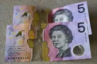 FILE - Australian $5 notes are pictured in Sydney on Sept. 10, 2022. King Charles III won’t feature on Australia's new $5 bill, the nation's central bank announced Thursday, Feb. 2, 2023, signaling a phasing out of the British monarchy from Australian bank notes, although he is still expected to feature on coins. (AP Photo/Mark Baker, File)