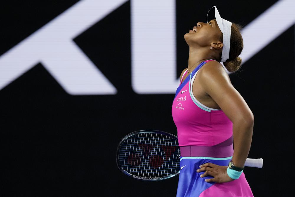 Naomi Osaka of Japan reacts during her third round match against Amanda Anisimova of the U.S. at the Australian Open tennis championships in Melbourne, Australia, Friday, Jan. 21, 2022. (AP Photo/Simon Baker)