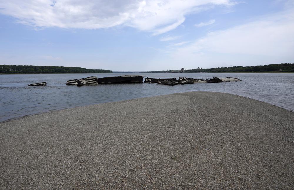 The wreckage of a WWII German warship is seen in the Danube river near Prahovo, Serbia, Monday, Aug. 29, 2022. The worst drought in Europe in decades has not only scorched farmland and hampered river traffic, it also has exposed a part of World War II history that had almost been forgotten. The hulks of dozens of German battleships have emerged from the mighty Danube River as its water levels dropped. (AP Photo/Darko Vojinovic)