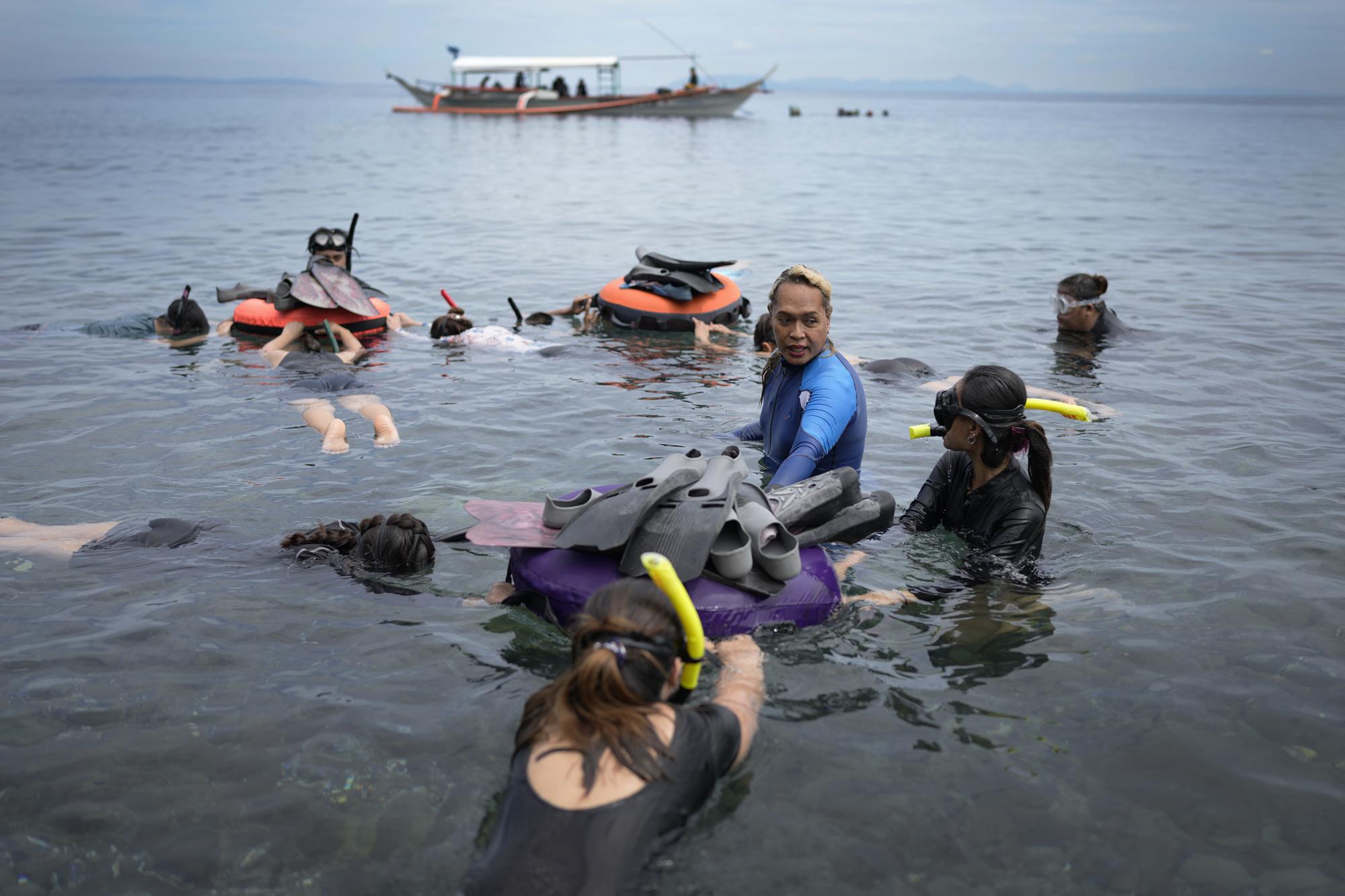 Queen Pangke Tabora conducts a freediving classs at the Ocean Camp in Mabini, Batangas province, Philippines on Saturday, May 21, 2022. There was a pivotal moment in her life that eclipsed all others: It was the moment, she says, when she first slid her legs into a mermaid tail. (AP Photo/Aaron Favila)
