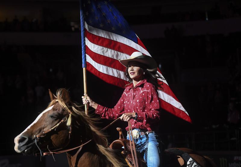 FILE - South Dakota Gov. Kristi Noem presents a United States flag in Sioux Falls, S.D., on July 11, 2020. Noem's election-year fight with fellow Republicans in the Legislature has spurred criticism she is neglecting her job to angle for the White House. (Abigail Dollins/The Argus Leader via AP, File)