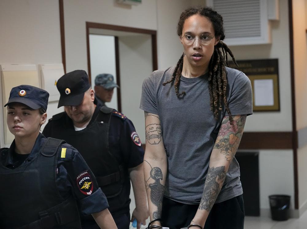 FILE - WNBA star and two-time Olympic gold medalist Brittney Griner is escorted from a courtroom after a hearing in Khimki just outside Moscow, Russia, on Aug. 4, 2022. A Russian court on Tuesday started hearing American basketball star Brittney Griner's appeal against her nine-year prison sentence for drug possession. (AP Photo/Alexander Zemlianichenko, File)