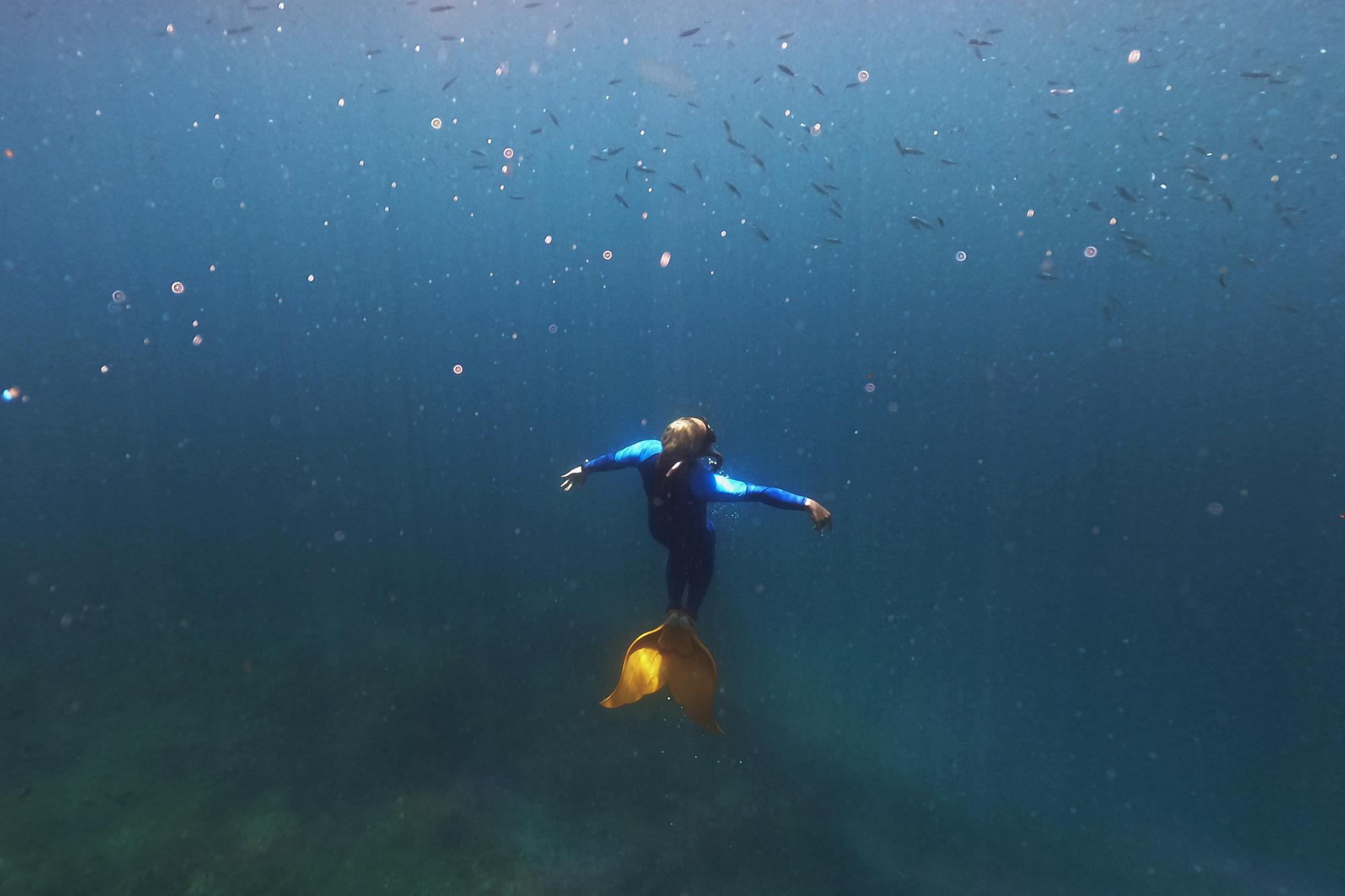 Queen Pangke Tabora swims in her monofin as she demonstrates techniques to her mermaiding class in Mabini, Batangas province, Philippines on Saturday, May 21, 2022. The former insurance company worker described the experience of gliding under water, half-human and half-fish, as “meditation in motion.” (AP Photo/Aaron Favila)