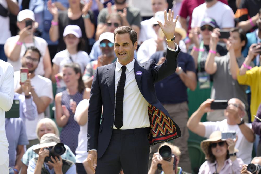 FILE - Switzerland's Roger Federer waves during a 100 years of Centre Court celebration on day seven of the Wimbledon tennis championships in London, on July 3, 2022. Federer announced Thursday, Sept. 15, 2022 he is retiring from tennis. (AP Photo/Kirsty Wigglesworth, File)