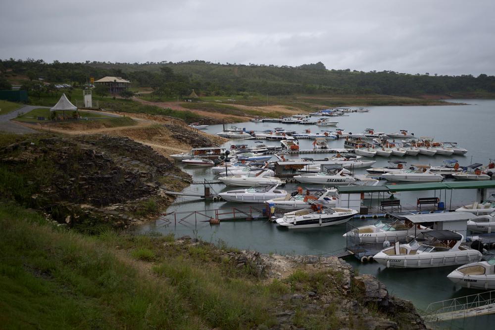 Tourist boats remain docked at a pier ot the Furnas reservoir after a massive slab of rock broke away from a cliff and toppled onto pleasure boaters on Saturday, killing at least seven people near Capitolio city, Brazil, Sunday, Jan. 9, 2022. (AP Photo/Igor do Vale)