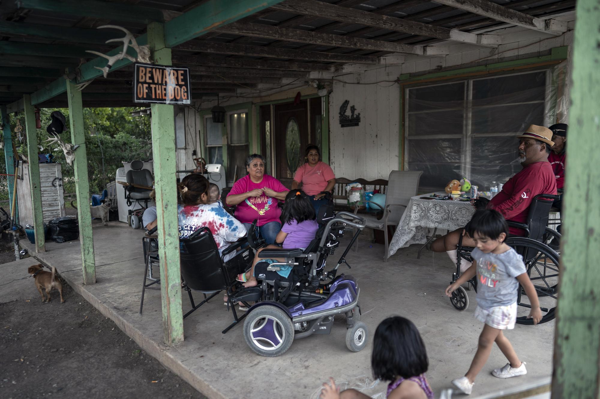 The family of 8-year-old Jeremiah Lennon sits in their front yard at home, Saturday, May 28, 2022, in Uvalde, Texas. The third grader had been in classroom 112, just next to the rooms where the shooter holed up. The kids in his class sat on the ground in the corner, as quiet as they could be, he said. The gunman tried to get in but the door was locked. Jeremiah said he was mad at first, because they were missing recess. He was also terrified: "I was scared I would get shot, my friends would get shot." (AP Photo/Wong Maye-E)
