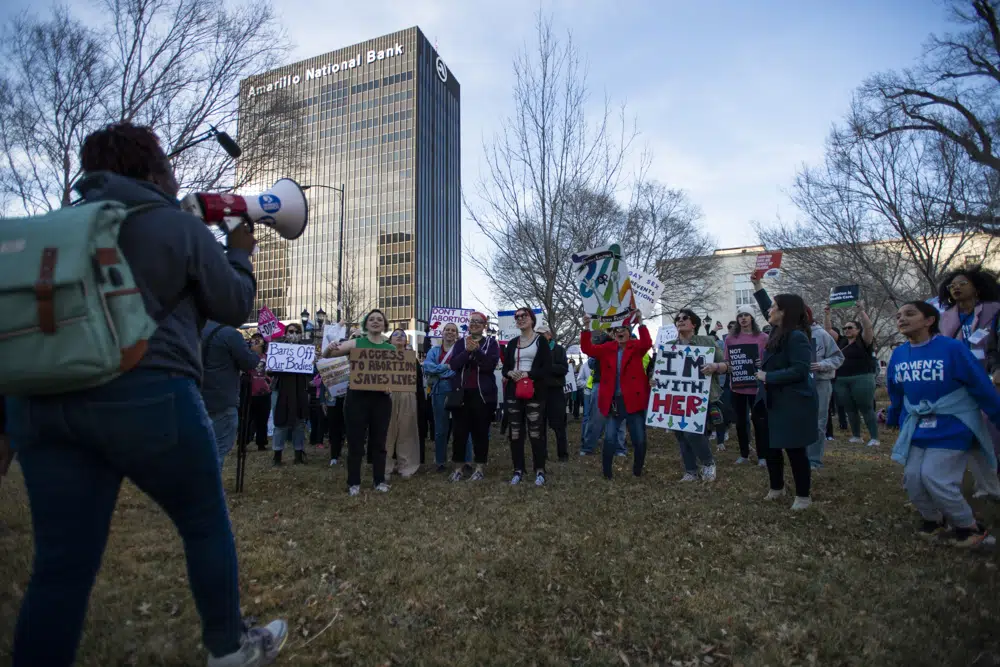 People gather in front of the J. Marvin Jones Federal Building and Mary Lou Robinson United States Courthouse to protest a lawsuit to ban the abortion drug mifepristone Saturday, Feb. 11, 2023, in Amarillo, Texas. (AP Photo/Justin Rex)