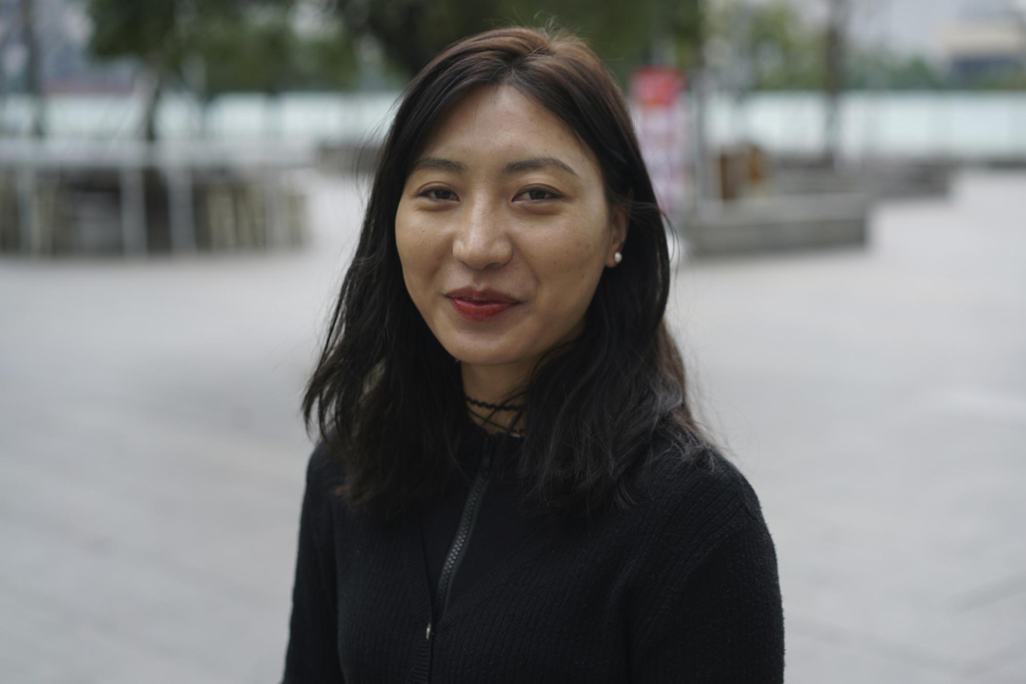 Kunchok Dolma, a Tibetan dance teacher who is also proud be a Chinese, poses for a photo in Chengdu in southwestern China's Sichuan province on Tuesday, Feb. 8, 2022.  "I am a true Tibetan, and at the same time I am also a true Chinese," said Kunchok Dolma, who is a devout Buddhist and also teaches modern dance in flawless Mandarin. (AP Photo/Dake Kang)