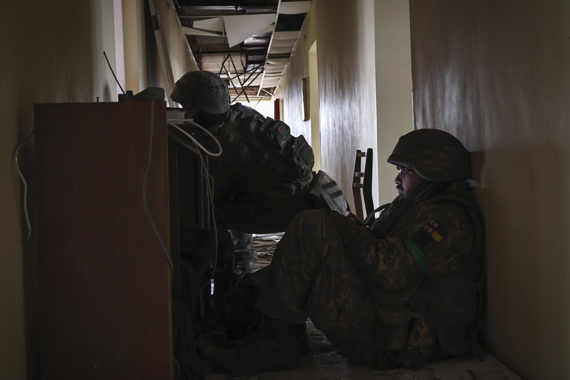 Ukrainian soldiers take a break in building in the area of the heaviest battles with the Russian invaders in Bakhmut, Donetsk region, Ukraine, Wednesday, March 15, 2023. (AP Photo/Roman Chop)