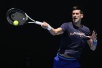 Defending men's champion Serbia's Novak Djokovic practices on Rod Laver Arena ahead of the Australian Open tennis championship in Melbourne, Australia, Wednesday, Jan. 12, 2022. AP Photo/Mark Baker)