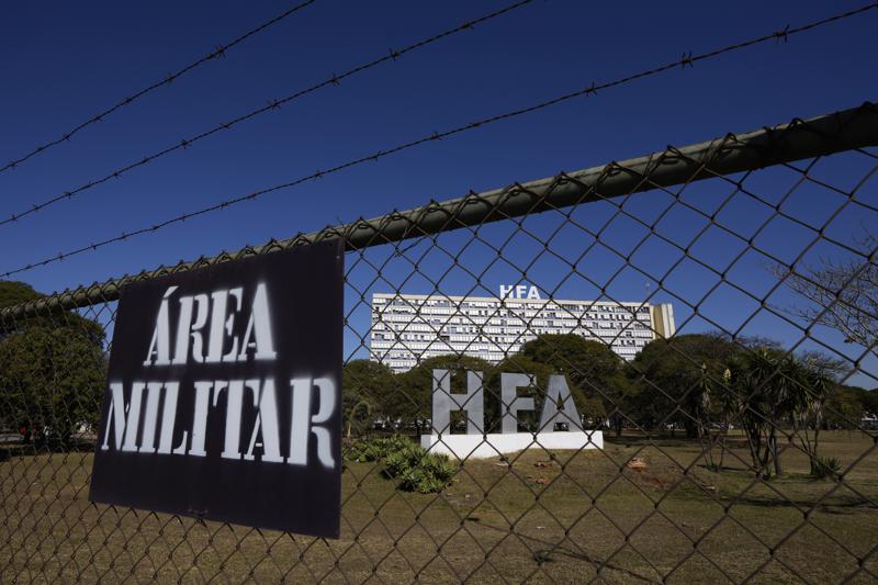 A fence surrounds the Armed Forces Hospital where Brazilian President Jair Bolsonaro was admitted in Brasilia, Brazil, Wednesday, July 14, 2021. Bolsonaro was admitted Wednesday to determine what is causing a hiccup that has lasted for days, according to a statement from the President’s office. (AP Photo/Eraldo Peres)