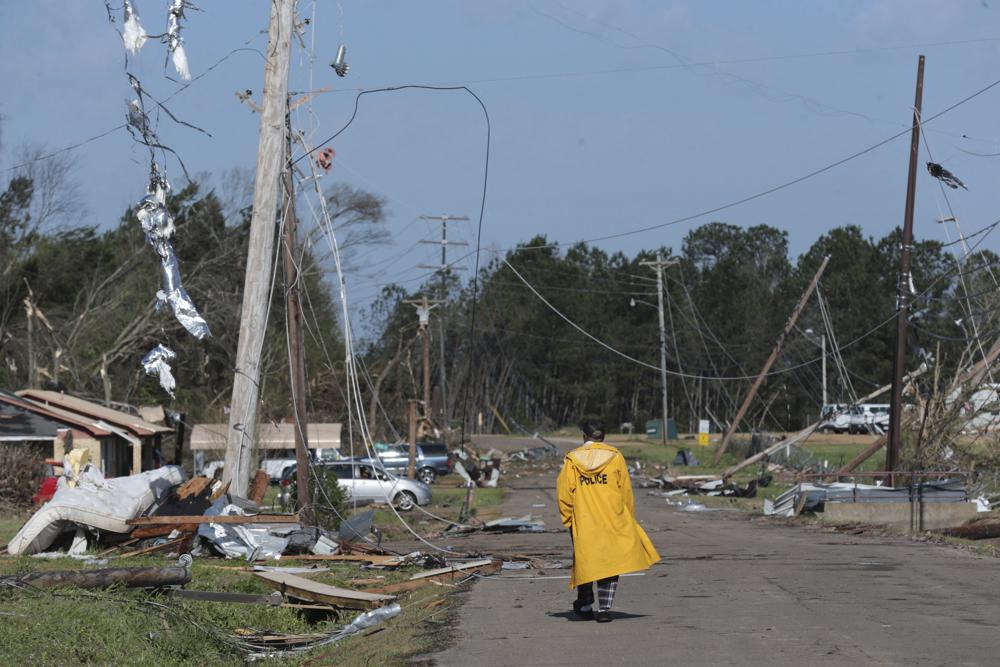 Barrie Young makes his way down the street to go and check on a neighbor Saturday, March 25, 2023 in Amory, Miss. Emergency officials in Mississippi say several people have been killed by tornadoes that tore through the state on Friday night, destroying buildings and knocking out power as severe weather produced hail the size of golf balls moved through several southern states (Thomas Wells/The Northeast Mississippi Daily Journal via AP)