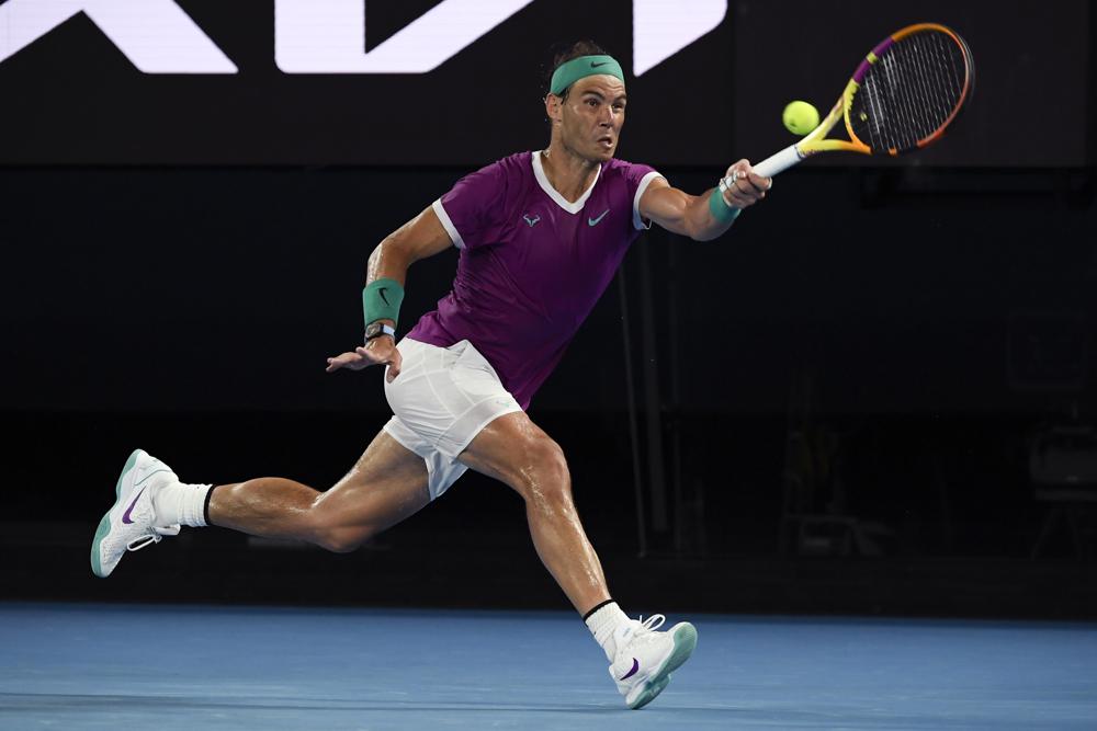 Rafael Nadal of Spain plays a forehand return to Daniil Medvedev of Russia during the men's singles final at the Australian Open tennis championships in Melbourne, Australia, Sunday, Jan. 30, 2022. (AP Photo/Andy Brownbill)