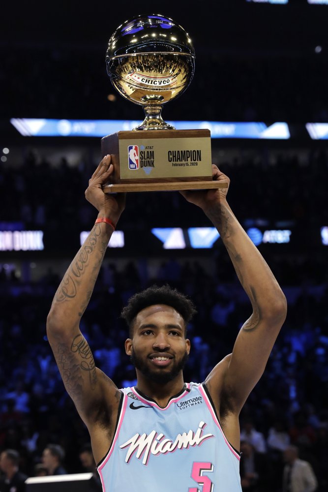 Miami Heat's Derrick Jones Jr. holds the trophy after he won the NBA All-Star slam dunk contest in Chicago, Saturday, Feb. 15, 2020. (AP Photo/Nam Y. Huh)