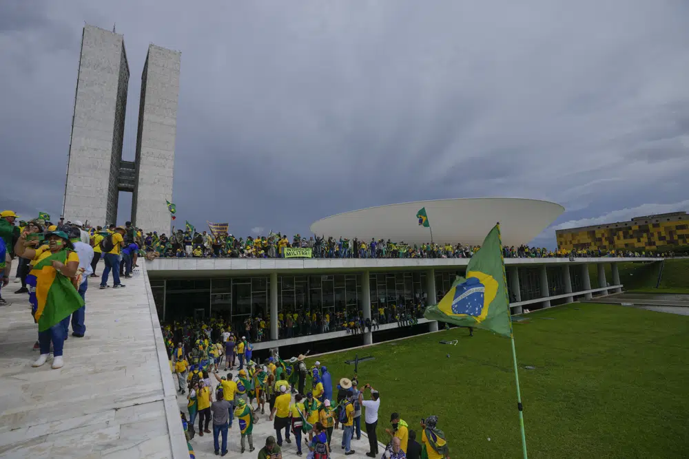 Protesters, supporters of Brazil's former President Jair Bolsonaro, storm the the National Congress building in Brasilia, Brazil, Sunday, Jan. 8, 2023. (AP Photo/Eraldo Peres)