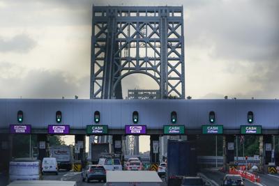 Cars pass through toll booths to use the George Washington Bridge in Fort Lee, N.J., Friday, July 8, 2022. The busy bridge connecting New Jersey and New York City is moving to cashless tolls. Beginning July 10, drivers paying cash tolls will have their license plates scanned and will be billed by mail. (AP Photo/Seth Wenig)