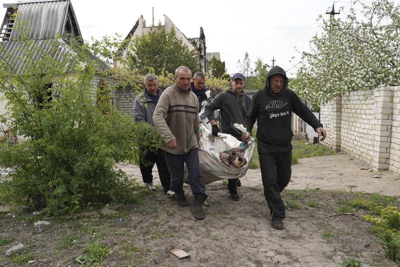 Volunteers exhume the bodies of civilians killed by Russian shelling in the village of Stepaky, close to Kharkiv, Ukraine, Wednesday, May 11, 2022. (AP Photo/Andrii Marienko)