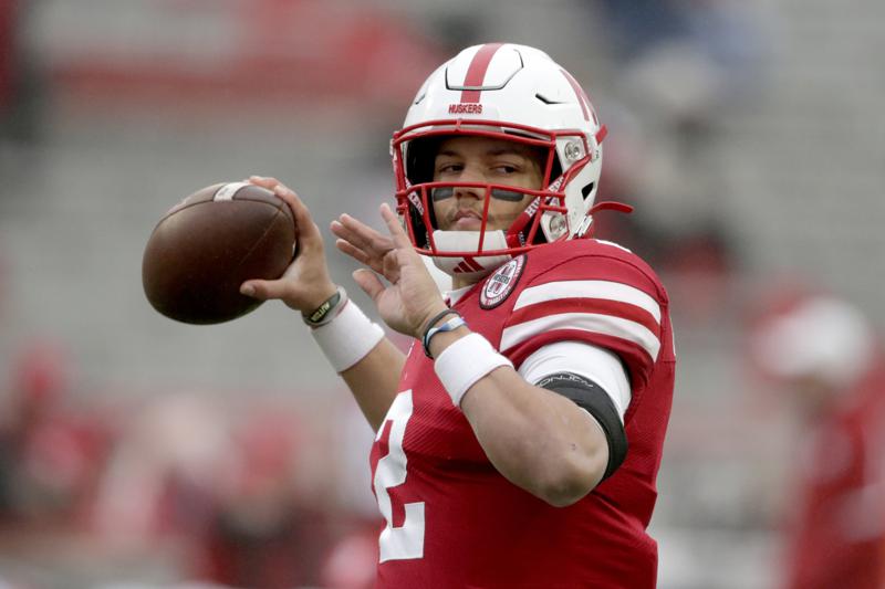 FILE - Nebraska quarterback Adrian Martinez warms up before an NCAA college football game against Iowa in Lincoln, Neb. in this Friday, Nov. 29, 2019, file photo. A new era in college sports has arrived. For the first time, NCAA athletes will be permitted to profit from their fame. Nebraska quarterback Adrian Martinez isn't a big social media guy, but he started thinking about ways to take advantage of the changes last fall. (AP Photo/Nati Harnik, File)