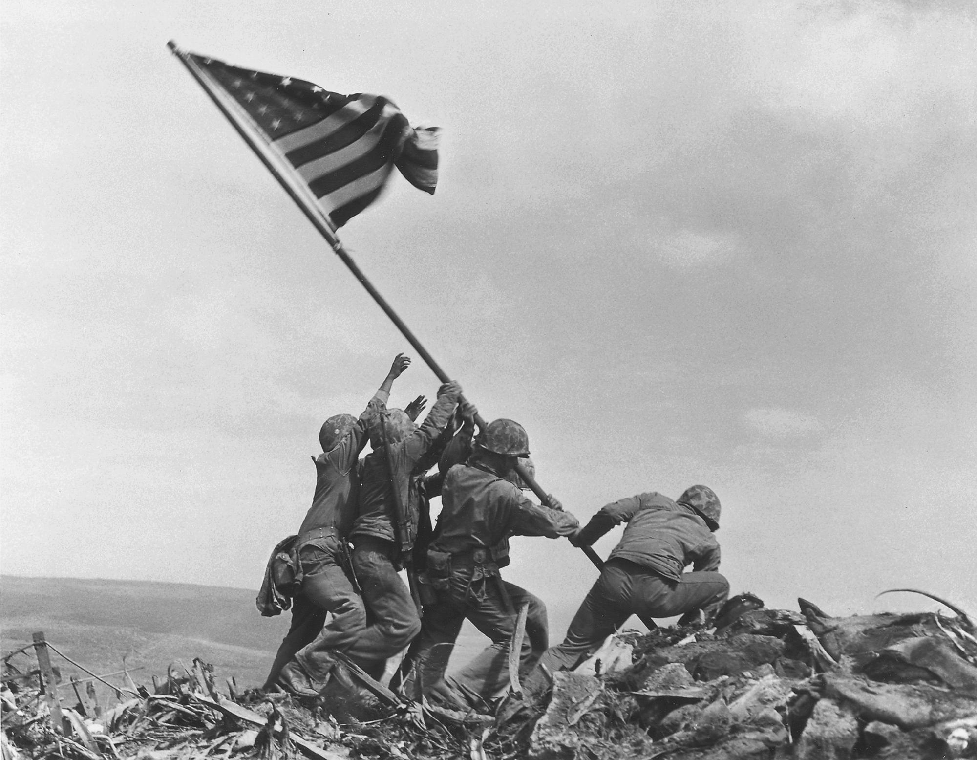 FILE - U.S. Marines of the 28th Regiment, 5th Division, raise the U.S. flag on Mt. Suribachi, Iwo Jima, Feb. 23, 1945. Strategically located only 660 miles from Tokyo, the Pacific island became the site of one of the bloodiest, most famous battles of World War II against Japan. (AP Photo/Joe Rosenthal, File)