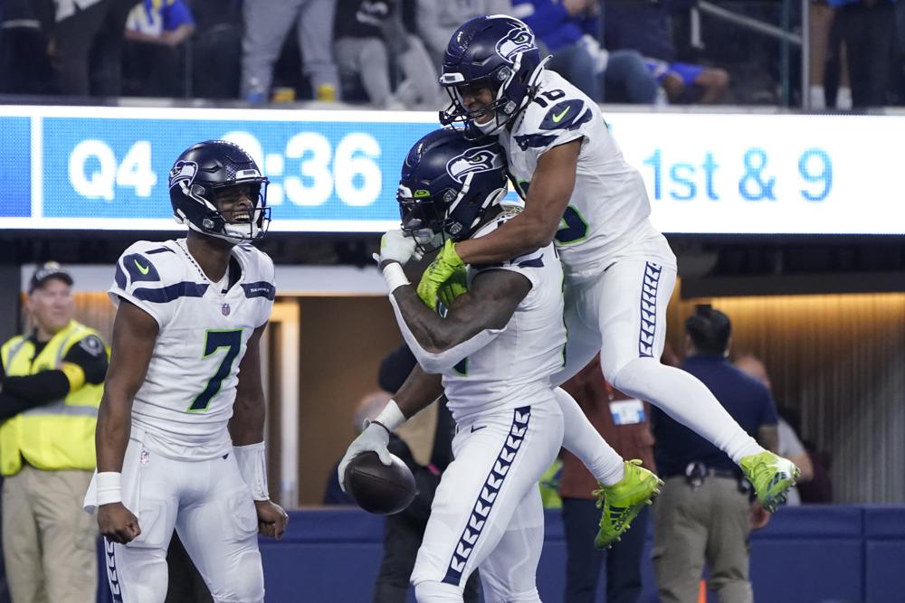 Seattle Seahawks wide receiver DK Metcalf, center, is congratulated by Geno Smith (7) and Tyler Lockett (16) after catching a touchdown pass during the second half of an NFL football game against the Los Angeles Rams Sunday, Dec. 4, 2022, in Inglewood, Calif. (AP Photo/Marcio Jose Sanchez)