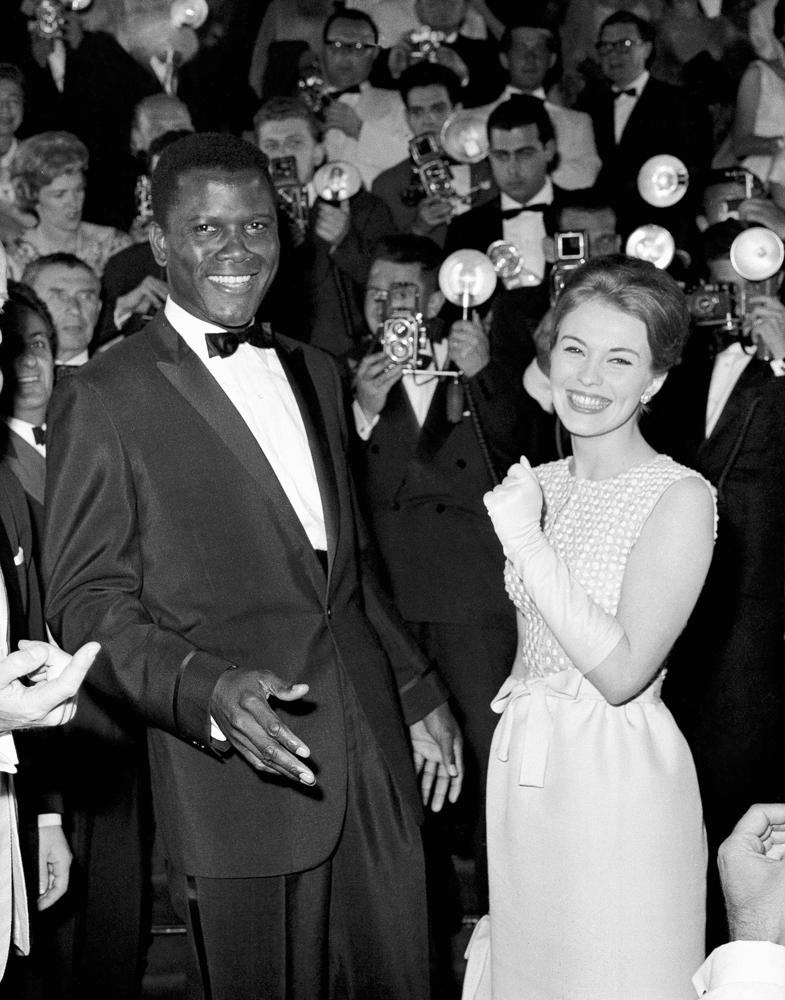 REMOVES REFERENCE TO THE BAHAMAS - FILE - Actors Sidney Poitier, left, and Jean Seberg appear at the Cannes Film Festival, Cannes, France, for the showing of his film "A Raisin in the Sun," on May 13, 1961. Poitier, the groundbreaking actor and enduring inspiration who transformed how Black people were portrayed on screen, became the first Black actor to win an Academy Award for best lead performance and the first to be a top box-office draw, died Thursday, Jan. 6, 2022. He was 94. (AP Photo, File)