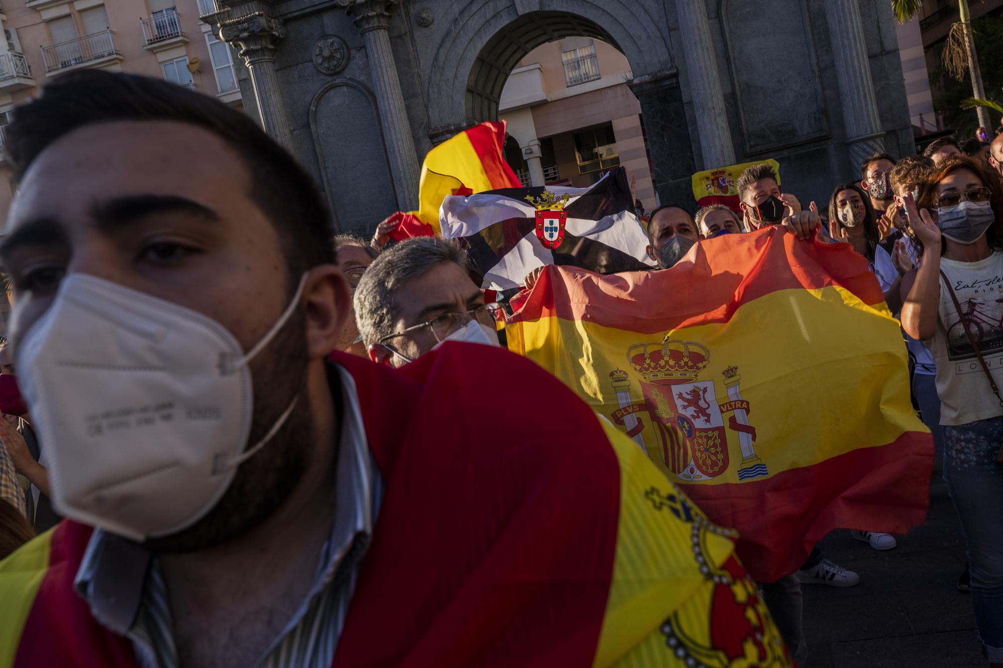 Spanish citizens gather during a protest against the arrival of migrants at the Spanish enclave of Ceuta, near the border of Morocco and Spain, on Tuesday, May 18, 2021. (AP Photo/Bernat Armangue)