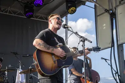 FILE - Zach Bryan performs at the Railbird Music Festival on Sunday, Aug. 29, 2021, in Lexington, Ky. The chorus against Ticketmaster's contentious concert pricing practices is growing, numbering among them Zach Bryan and friends.The country music artist dropped a live album, “All My Homies Hate Ticketmaster,” on Sunday, Dec. 25, 2022. With it came a statement posted to social media in which he decried “a massive issue with fair ticket prices to live shows lately.” (Photo by Amy Harris/Invision/AP, File)