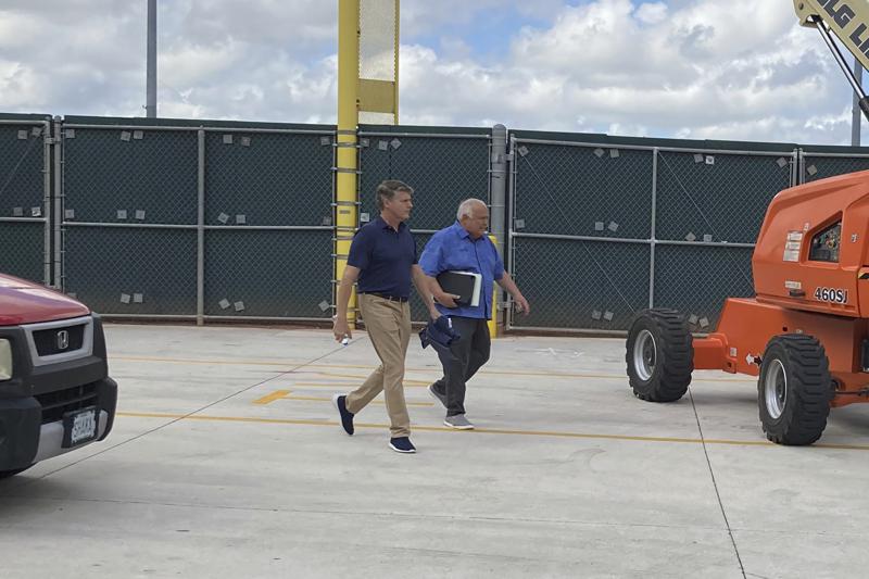 New York Yankees managing general partner Hal Steinbrenner, left, and San Diego Padres vice chairman Ron Fowler walk at Roger Dean Stadium in Jupiter, Fla., where baseball labor talks continue Thursday, Feb. 24, 2022. (AP Photo/Ron Blum)