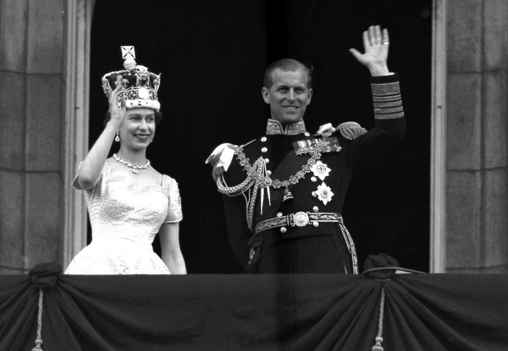 FILE - In this June. 2, 1953 file photo, Britain's Queen Elizabeth II and Prince Philip, Duke of Edinburgh wave to supporters from the balcony at Buckingham Palace, following her coronation at Westminster Abbey, London. Queen Elizabeth II, Britain’s longest-reigning monarch and a rock of stability across much of a turbulent century, has died. She was 96. Buckingham Palace made the announcement in a statement on Thursday Sept. 8, 2022. (AP Photo/Leslie Priest, File)