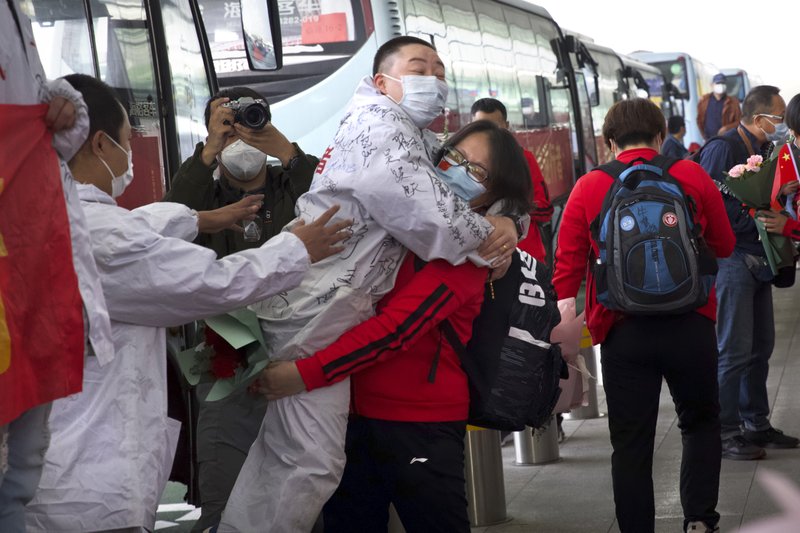 Masked crowds fill Wuhan's streets, trains as lockdown ends