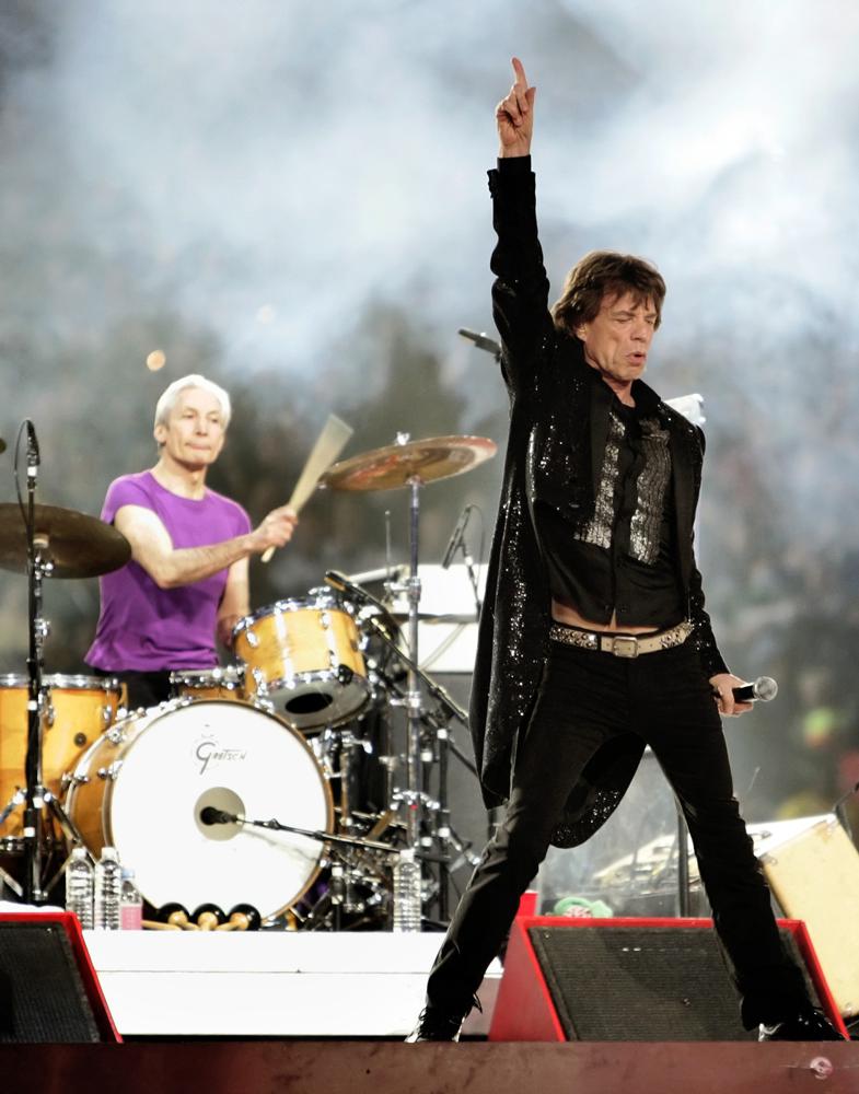 FILE - Mick Jagger, right, and drummer Charlie Watts, perform with the Rolling Stones at halftime of the Super Bowl XL football game in Detroit on Feb. 5, 2006. Watts' publicist, Bernard Doherty, said Watts passed away peacefully in a London hospital surrounded by his family on Tuesday, Aug. 24, 2021. He was 80.  (AP Photo/David J. Phillip, File)