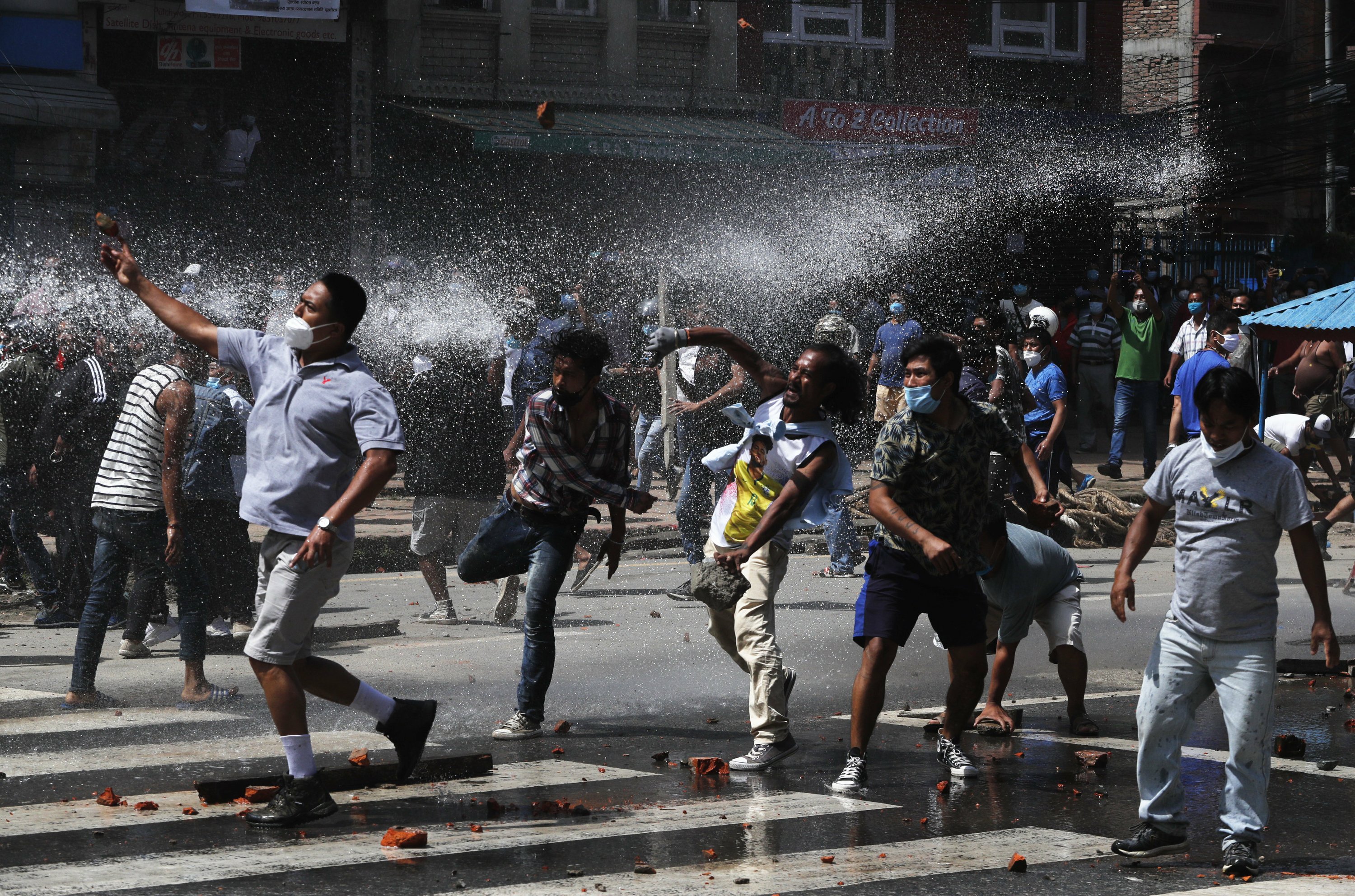 Nepal protesters defy virus lockdown, clash with riot police AP News