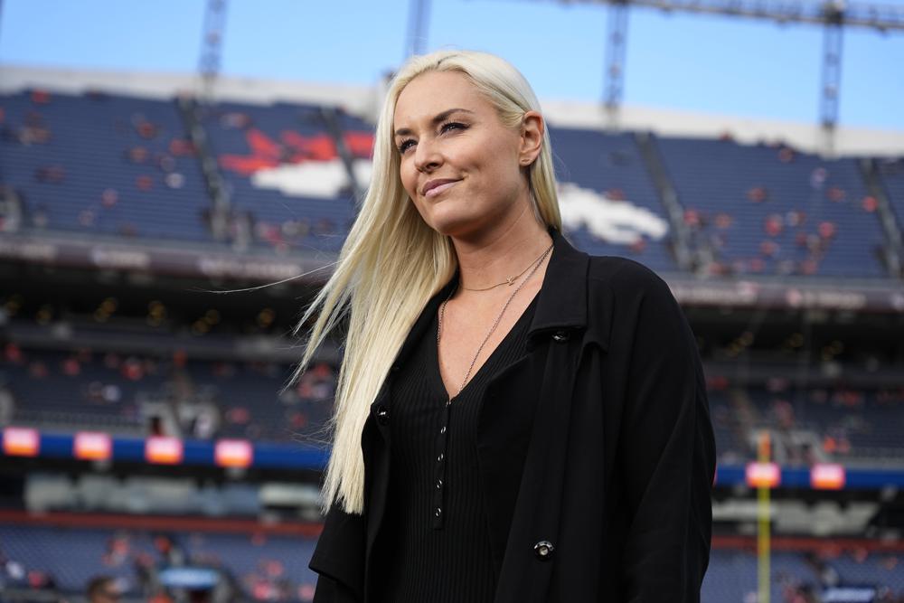 FILE - Lindsey Vonn stands on the sidelines prior to an NFL football game between the Philadelphia Eagles and the Denver Broncos, Nov. 14, 2021, in Denver. Vonn details in a column for The Associated Press on Tuesday, Dec. 28 the mental health challenges she faced after retiring from ski racing. The most successful female ski racer of all time says she needed to find a new outlet after releasing all of her troubles on the mountain for so many years. (AP Photo/Jack Dempsey, file)