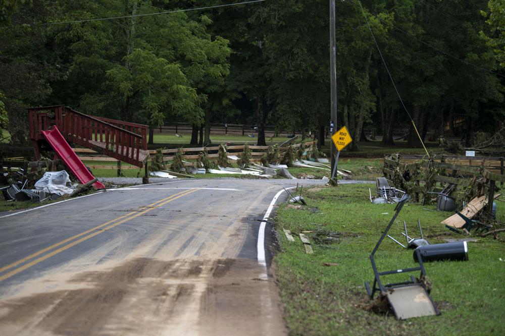 Debris from flooding is strewn along Sam Hollow Road following heavy rainfall on Saturday, Aug. 21, 2021, in Dickson, Tenn. (Josie Norris/The Tennessean via AP)