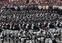 FILE - Members of Mexico's National Guard march in the Independence Day military parade, in the capital's main plaza, the Zocalo, in Mexico City, Sept. 16, 2019. Mexico’s President Andres Manuel Lopez Obrador has begun exploring plans to side-step congress to hand formal control of the National Guard to the army. That has raised concerns, because Lopez Obrador won approval for creating the force in 2019 by pledging in the constitution that it would be under nominal civilian control and that the army would be off the streets by 2024. (AP Photo/Marco Ugarte, File)